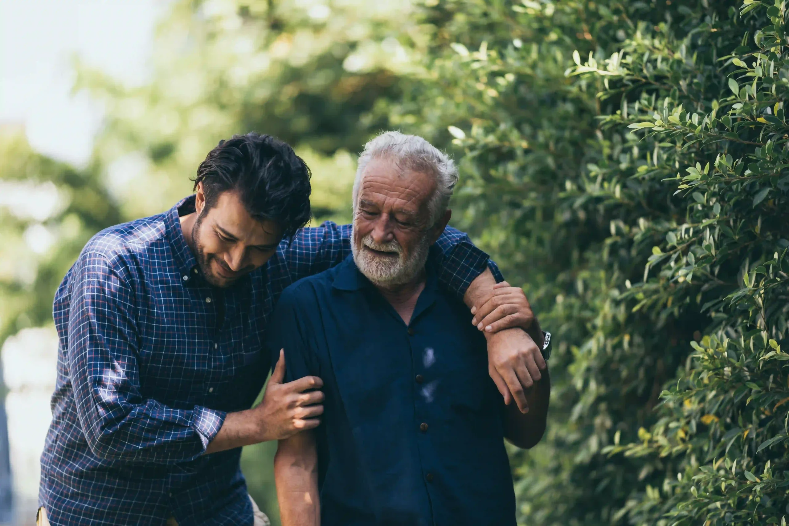 Final Expense Elderly man and his son walking outside