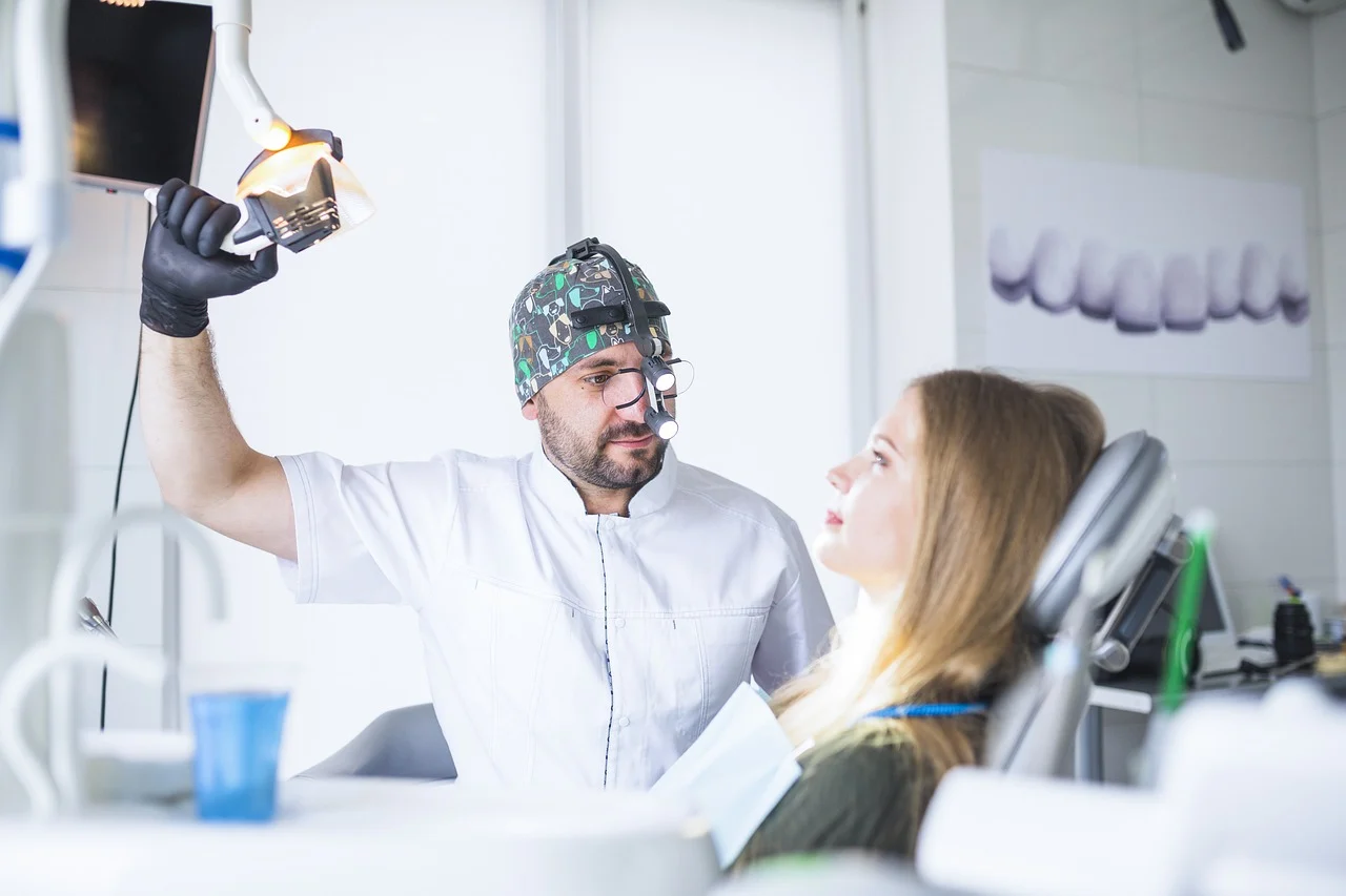 preventive-dentistry-8858477_1280 Dentist examining a patient's mouth.